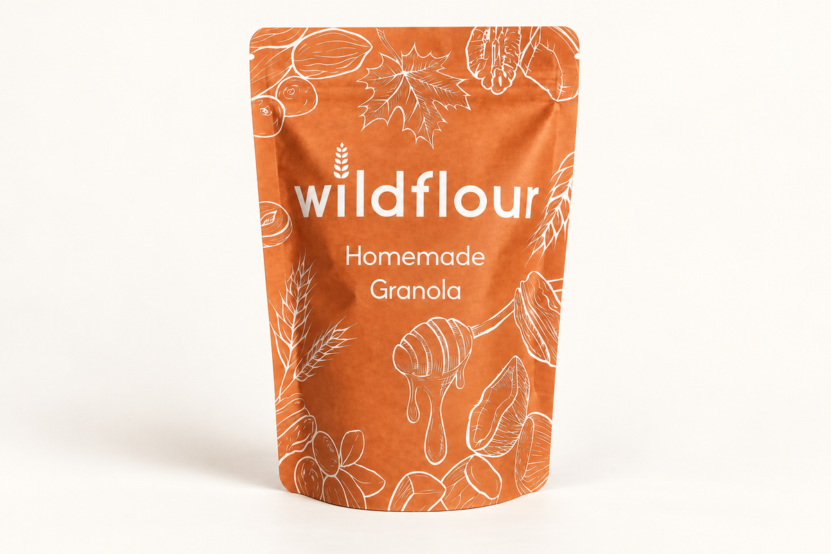 A pouch of Wildflour granola, centred against a plain background.